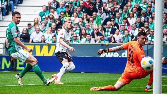 Bremens Torhüter Michael Zetterer (r.) und Milos Veljkovic (l.) können einen Treffer von Gladbachs Robin Hack nicht verhindern. © IMAGO / Eibner 